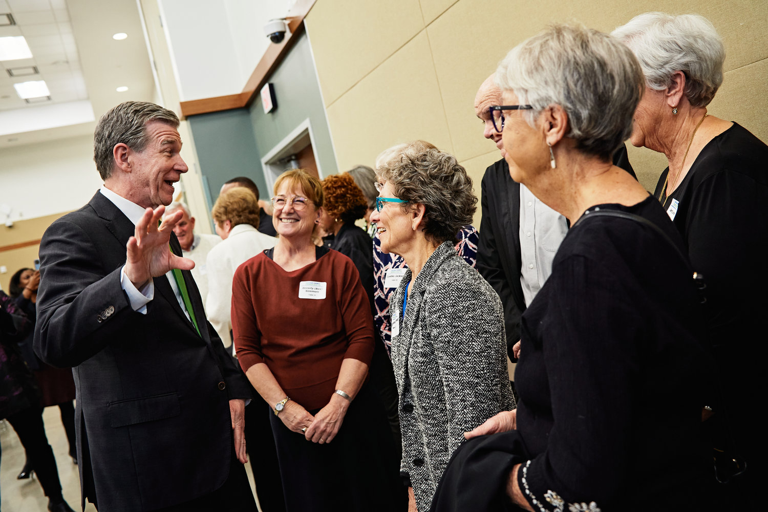 N.C. Gov. Roy Cooper visited Chatham County last Thursday, attending a Democratic Party event in Pittsboro at the invitation of Rep. Robert Reives II. Cooper, shown speaking with some attendees at the event, helped honor county volunteers and donors. ‘Our officer team is deeply indebted to Robert Reives’ campaign for making our event so incredibly successful,’ said Liz Guinan, who’s stepping down from the local party’s chairperson position. ‘Robert’s generous spirit is on display to all of us in Chatham County, as witnessed by his devotion to bringing manufacturing jobs to Chatham, his work in addressing Pittsboro’s water issues, his cooperation in negotiating a state budget, and a host of issues he fights for every day. Robert consistently works to improve lives in Chatham County, regardless of party affiliation. We cannot thank him enough.’ Cooper, Reives. Sen. Natalie Murdock and others spoke at the event, held at the Chatham County Agriculture & Conference Center.